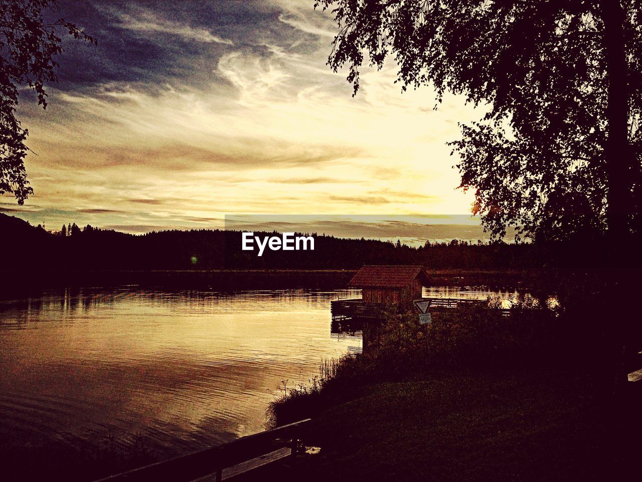 Scenic view of river against cloudy sky