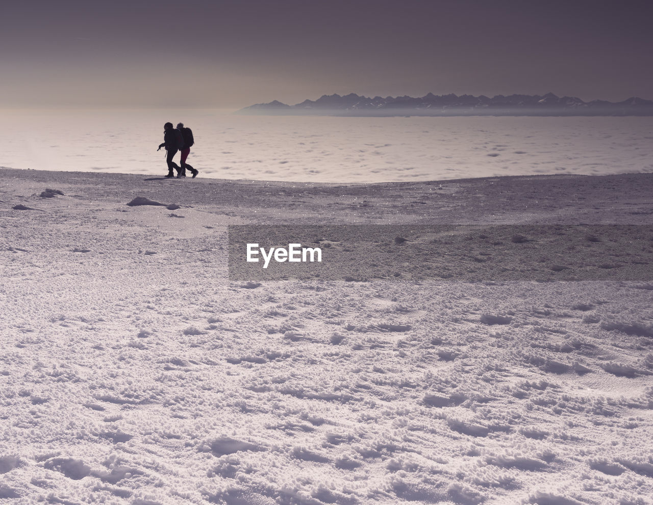 winter, snow, land, nature, sky, full length, cold temperature, environment, one person, landscape, leisure activity, skiing, beauty in nature, scenics - nature, sand, sports, holiday, wave, beach, adult, ocean, lifestyles, water, vacation, travel, walking, men, trip, sea, motion, horizon, travel destinations, silhouette, mountain, outdoors, activity, day, solitude, non-urban scene, sunlight, tranquility, clear sky, winter sports, adventure, footprint, natural environment, copy space
