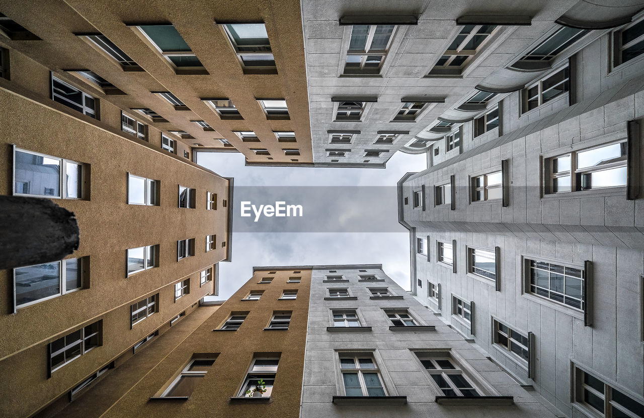 Directly below shot of buildings against sky