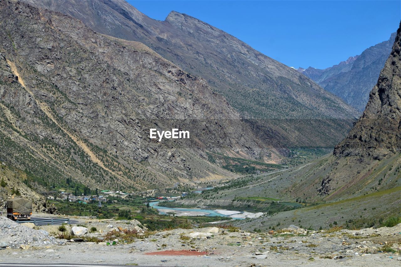 mountain, environment, landscape, scenics - nature, mountain range, beauty in nature, nature, land, mountain pass, valley, sky, no people, non-urban scene, day, tranquil scene, tranquility, rock, travel destinations, water, lake, travel, moraine, outdoors, walking, plant, geology, wadi, activity, wilderness, road, clear sky, blue, idyllic, plateau, tourism, tree