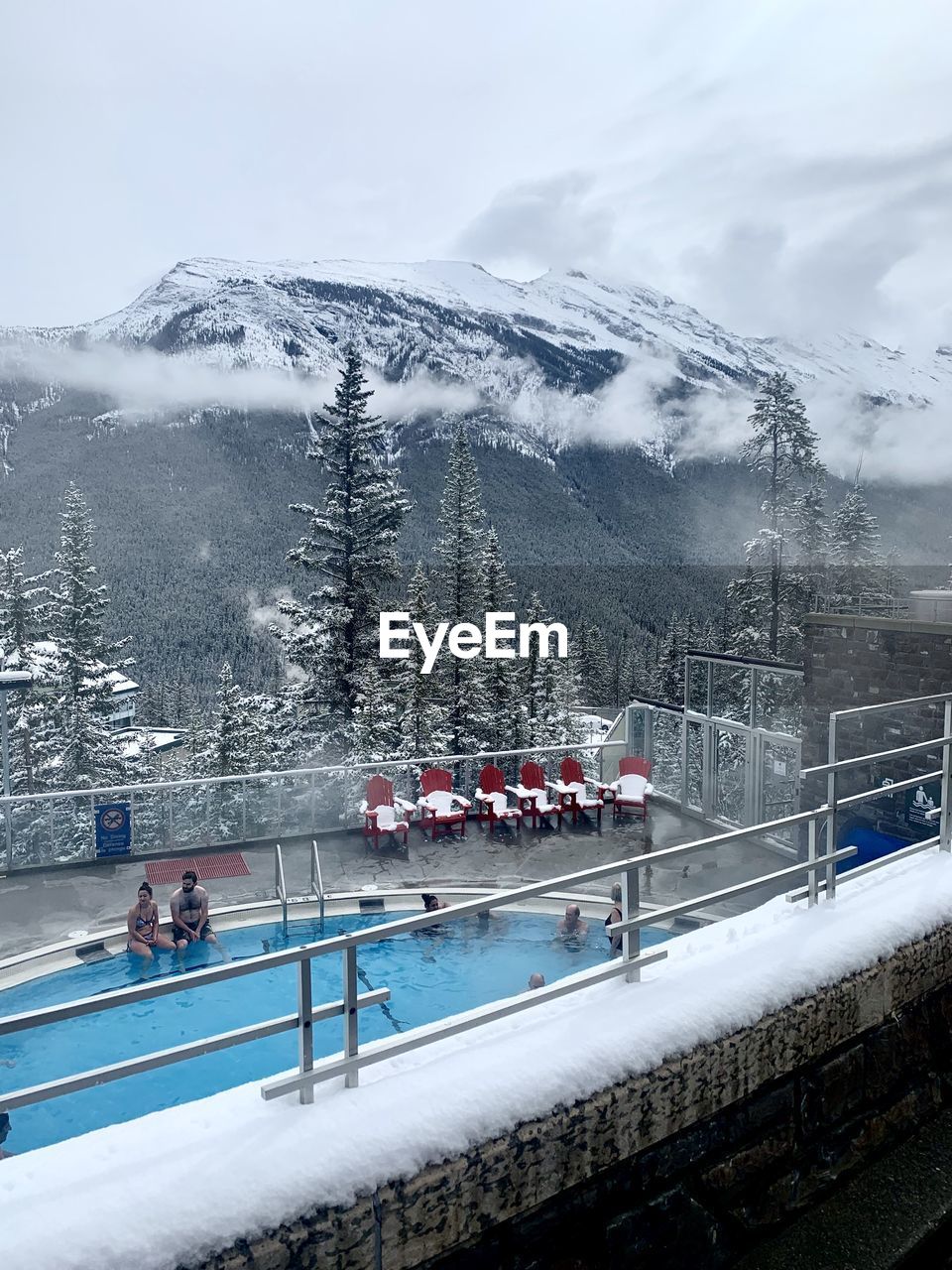 PEOPLE ON SNOWCAPPED MOUNTAIN AGAINST SKY