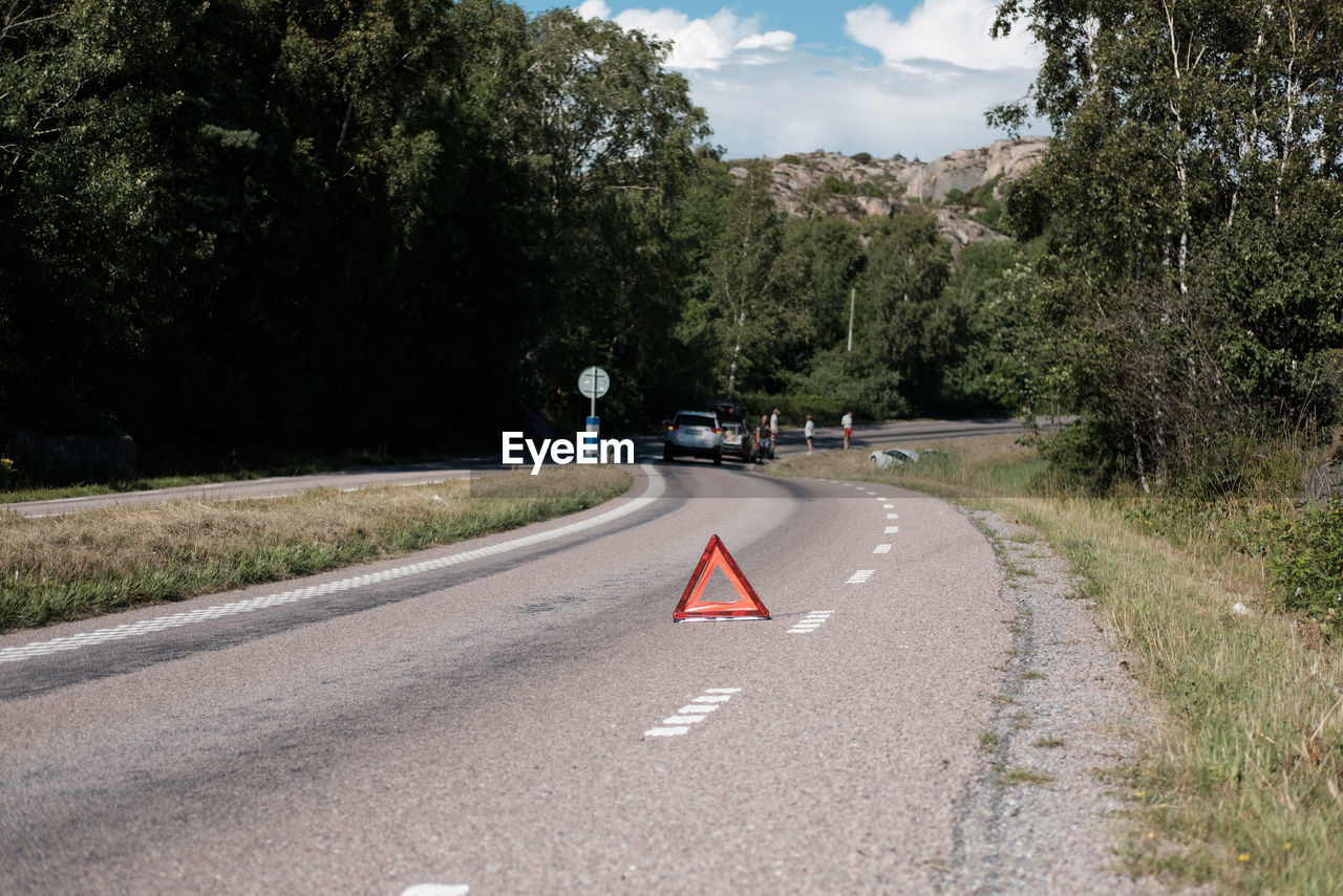 People standing by cars on road during accident