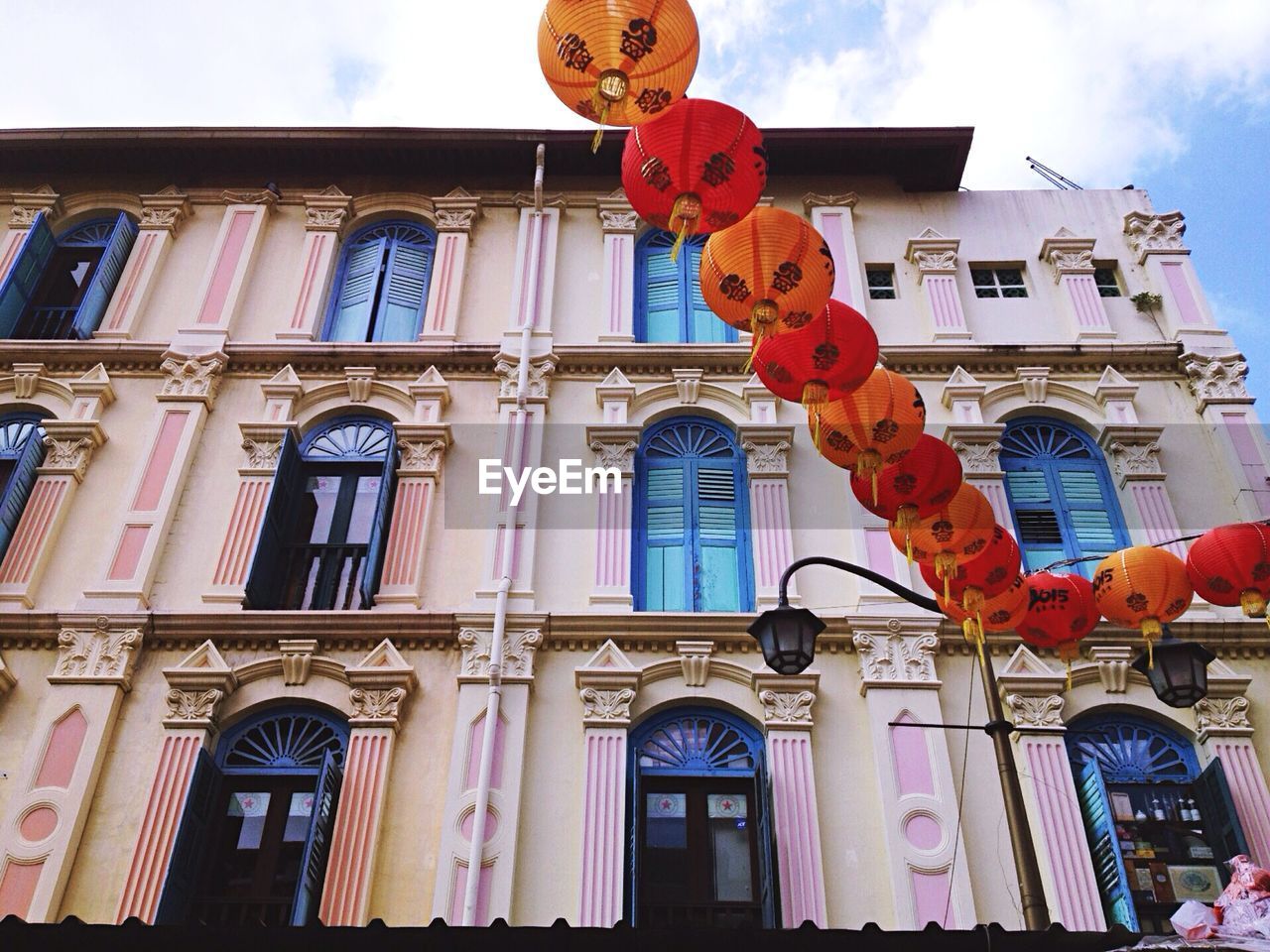 Low angle view of lanterns and building against sky