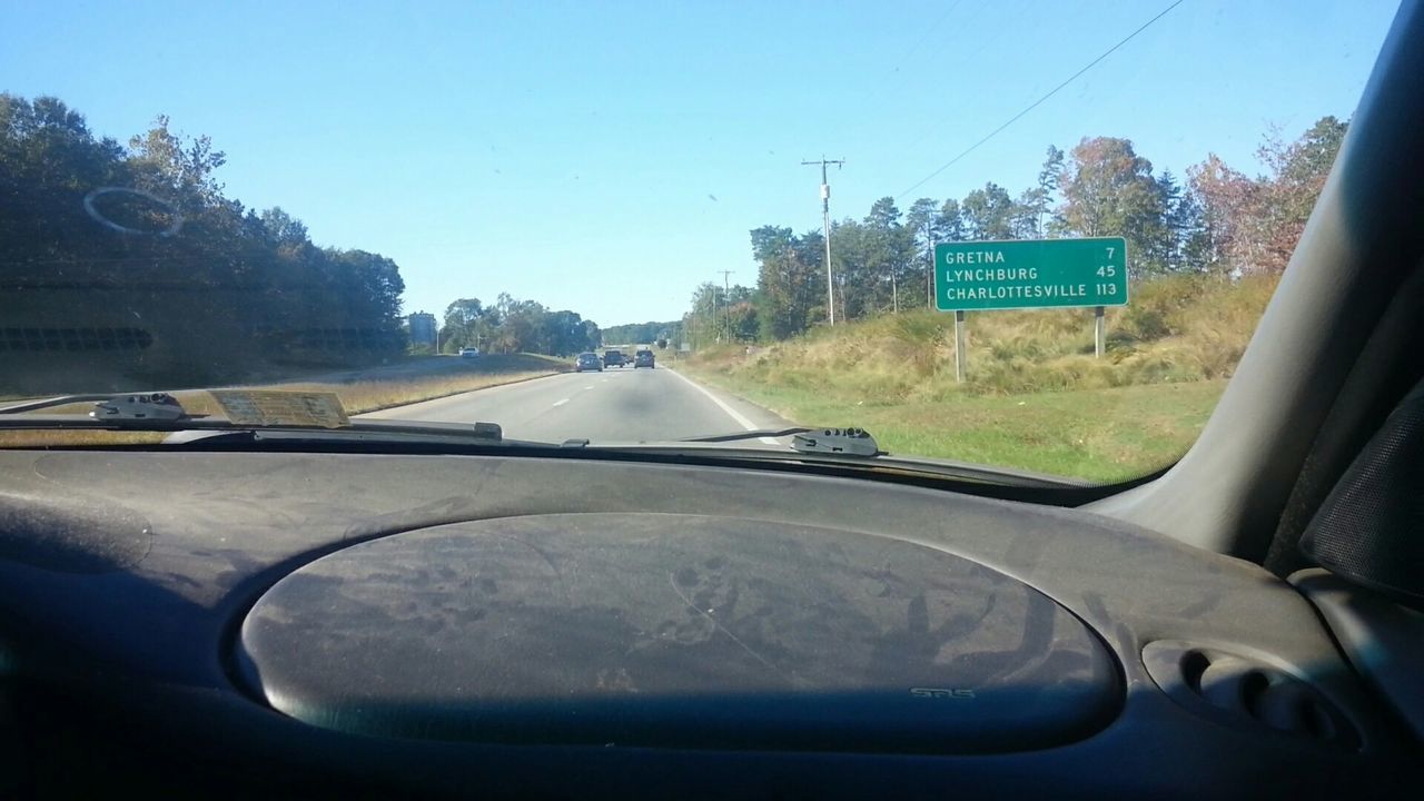 ROAD SEEN THROUGH WINDSHIELD OF CAR