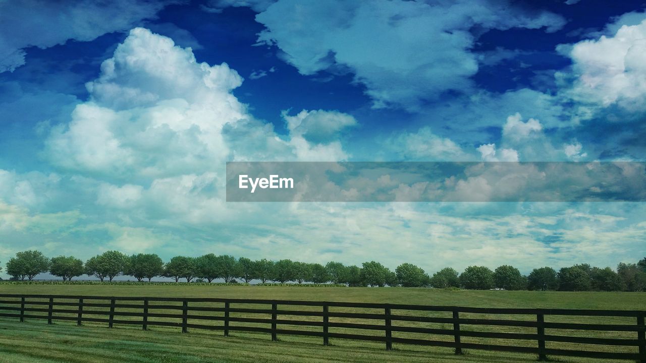 Scenic view of field against cloudy sky