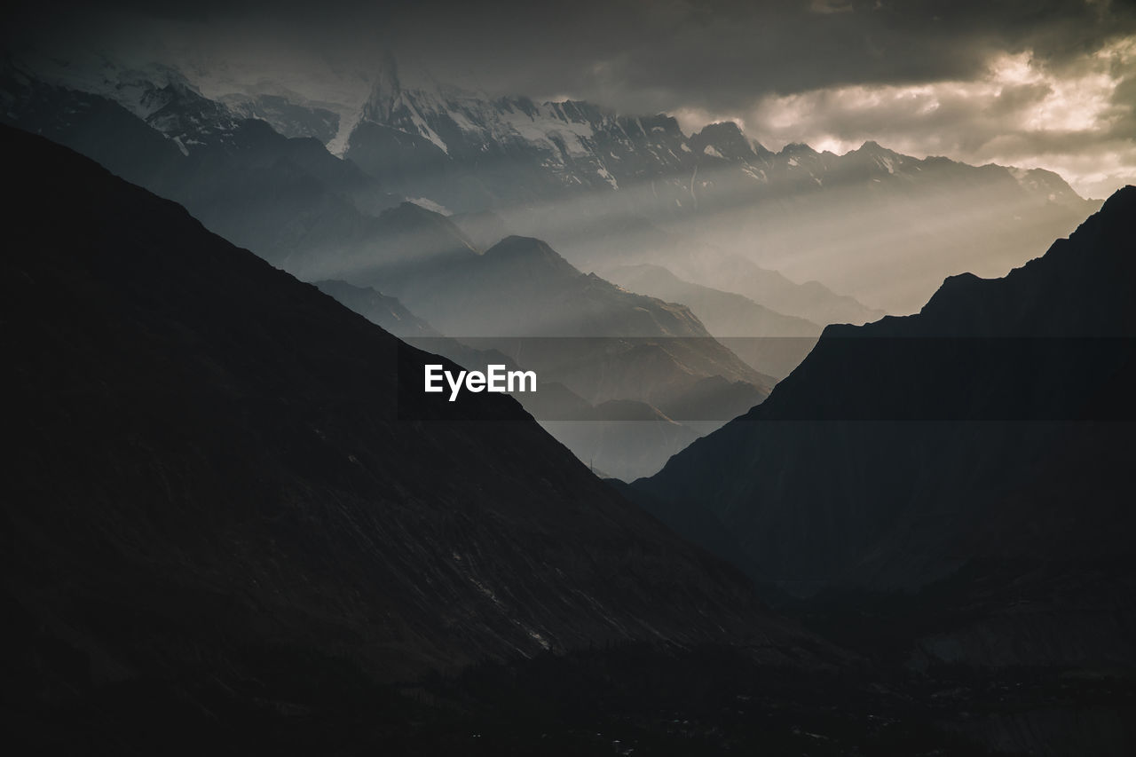 Scenic view of silhouette mountains against sky at dusk