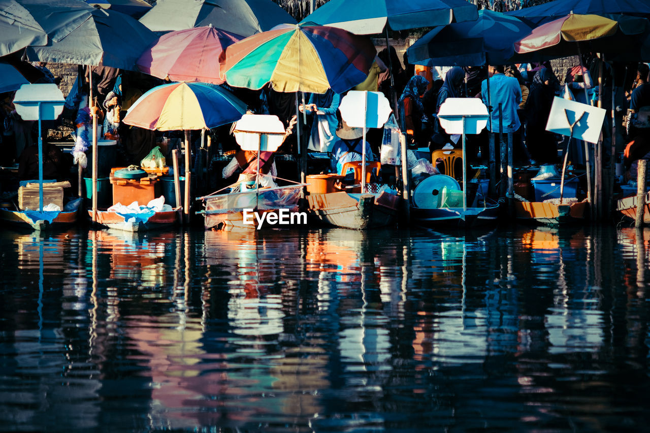 Boats with parasols moored in lake