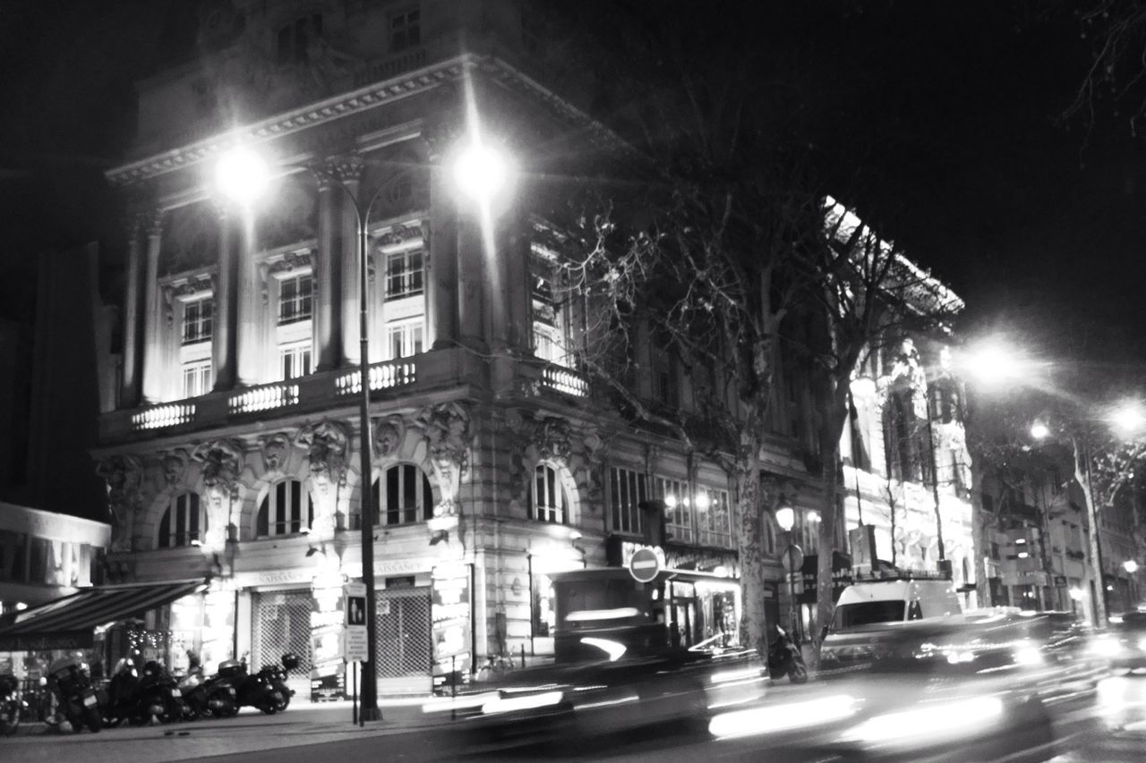 VIEW OF ILLUMINATED STREET AT NIGHT