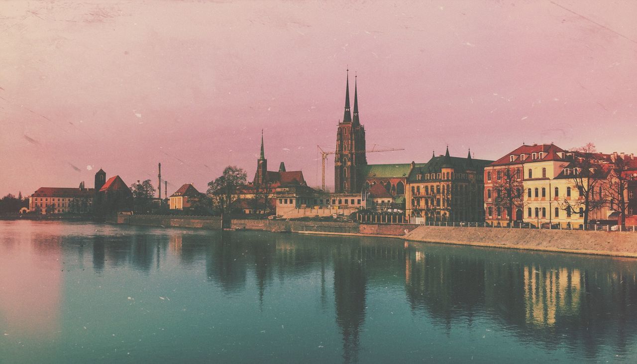 VIEW OF RIVER WITH BUILDINGS IN BACKGROUND