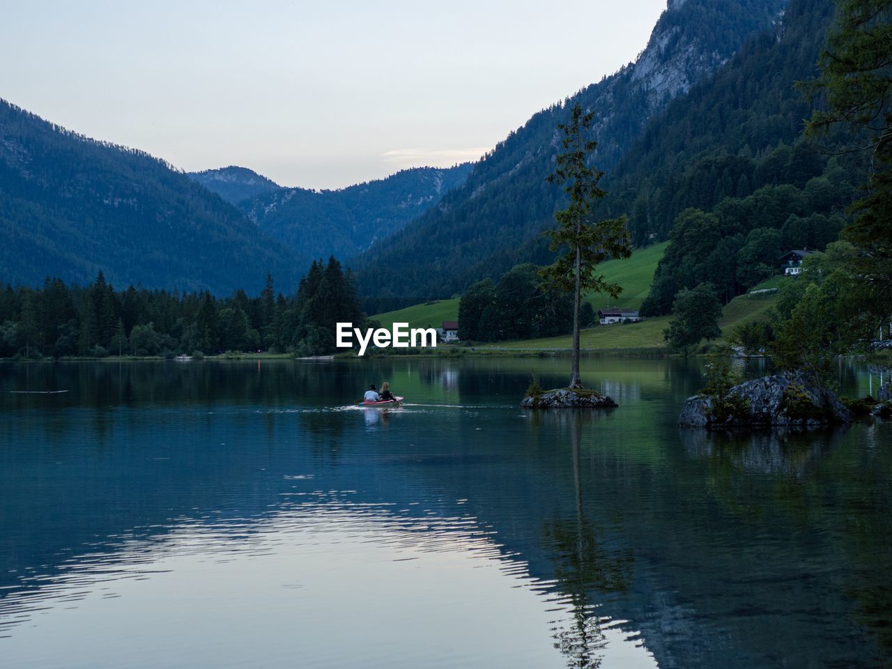 Scenic view of lake and mountains against sky