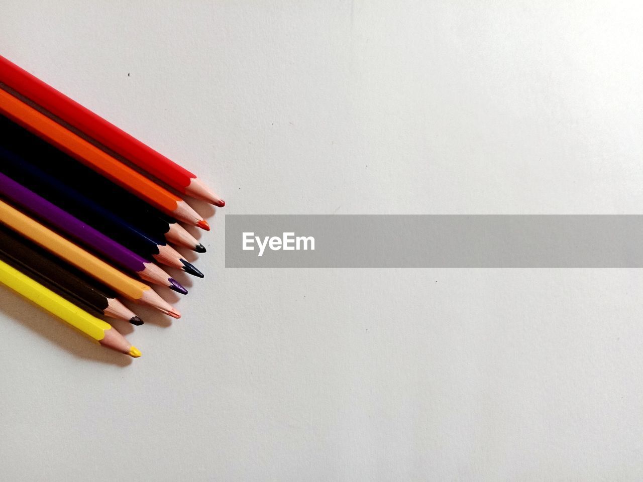 HIGH ANGLE VIEW OF PENCILS ON WHITE BACKGROUND