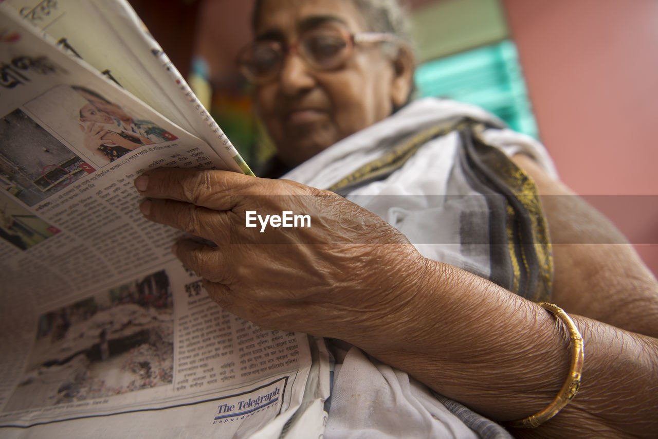 Lady reading the news paper