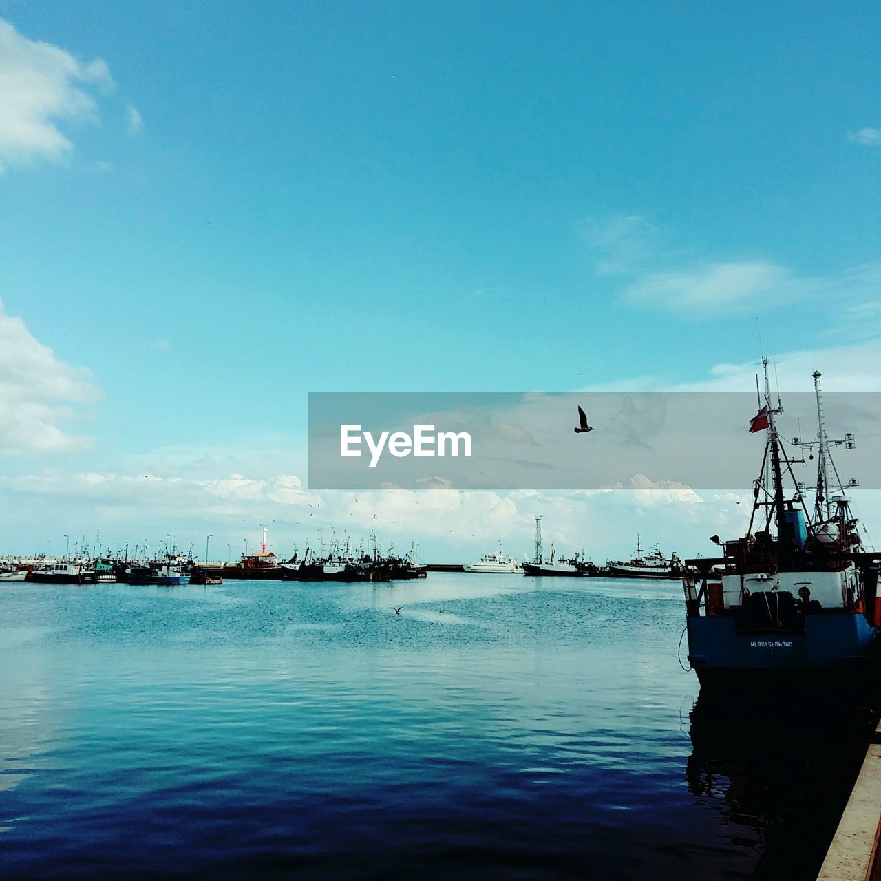 VIEW OF BOATS IN CALM SEA AGAINST SKY