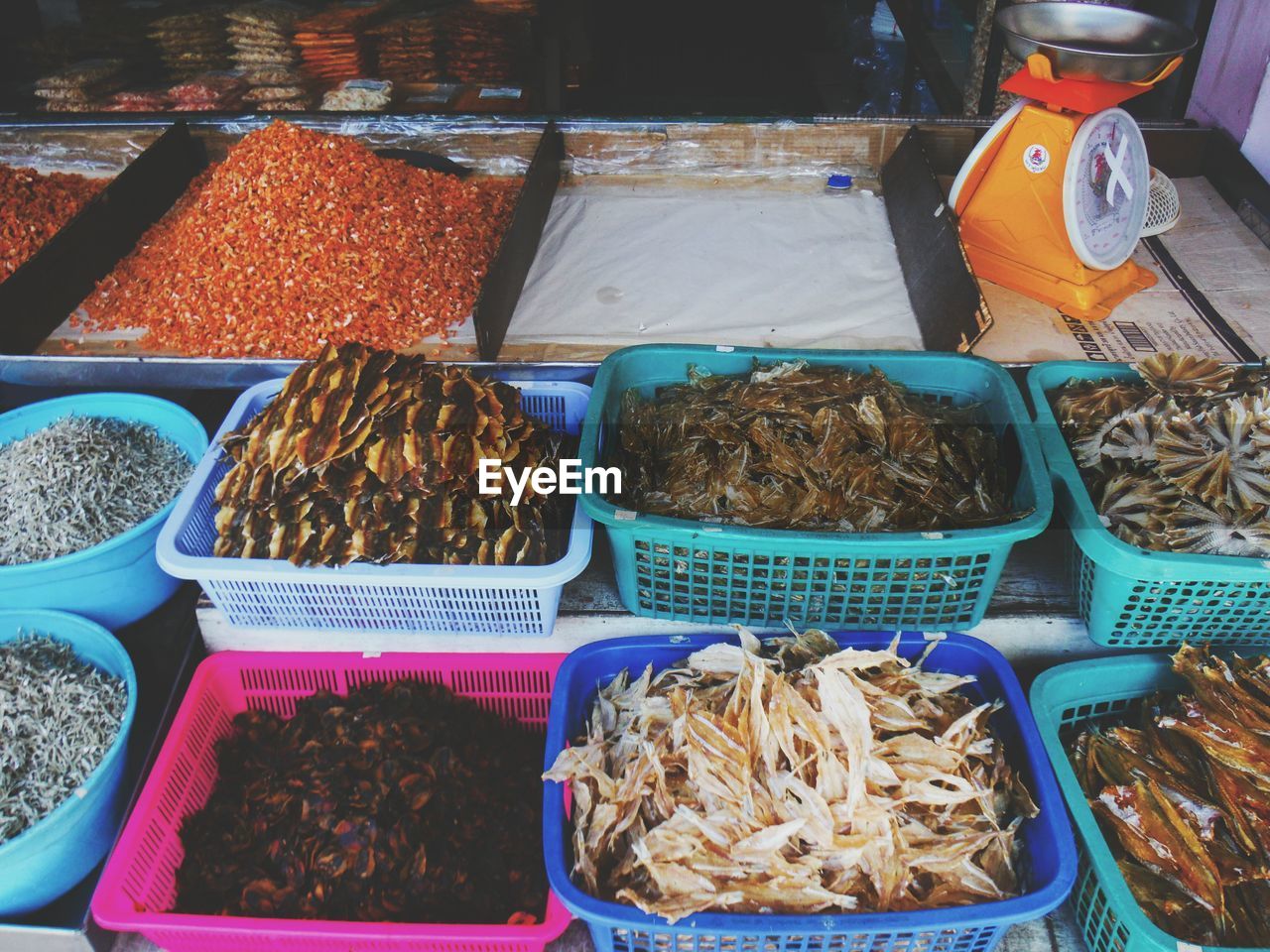 High angle view of dried fish in container for sale at market stall