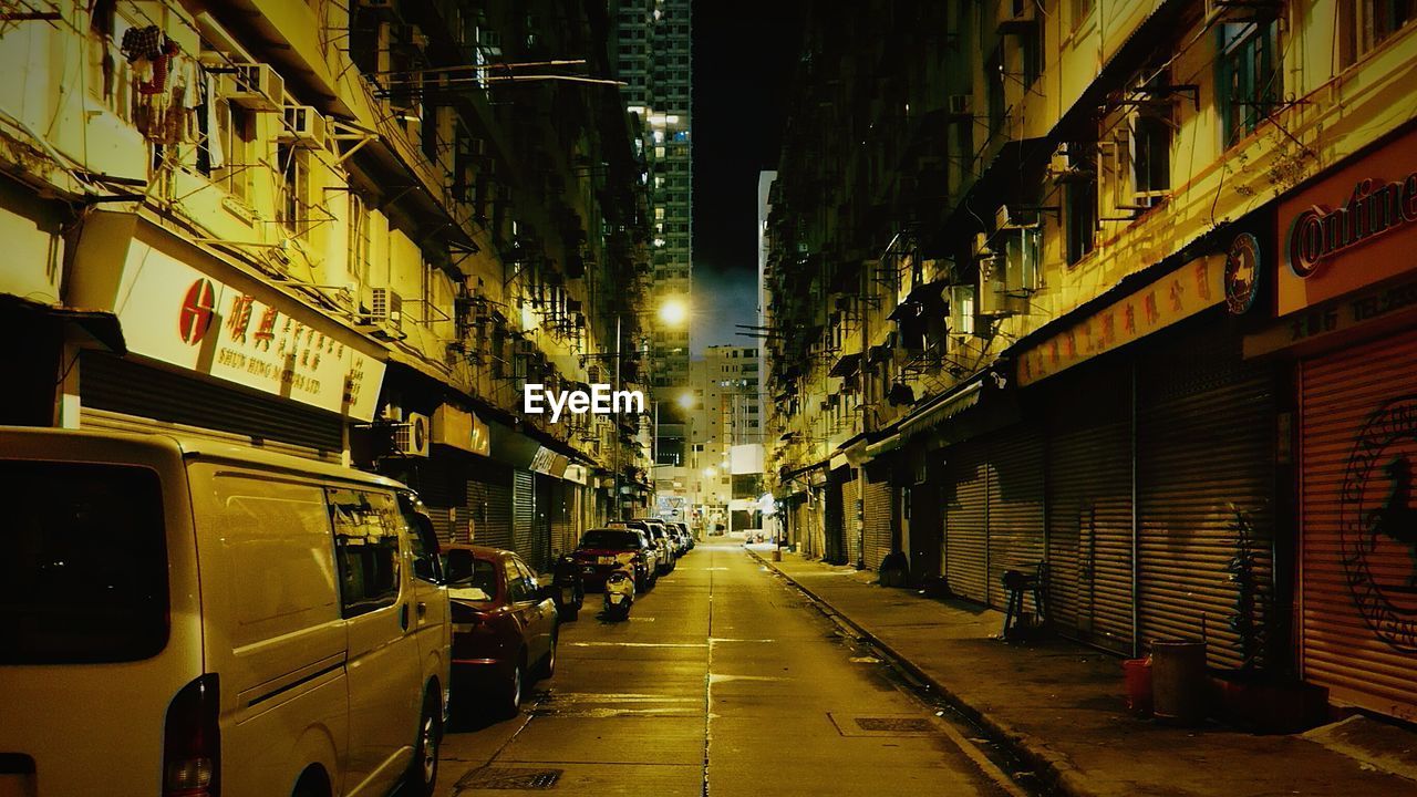 View of city street and buildings at night