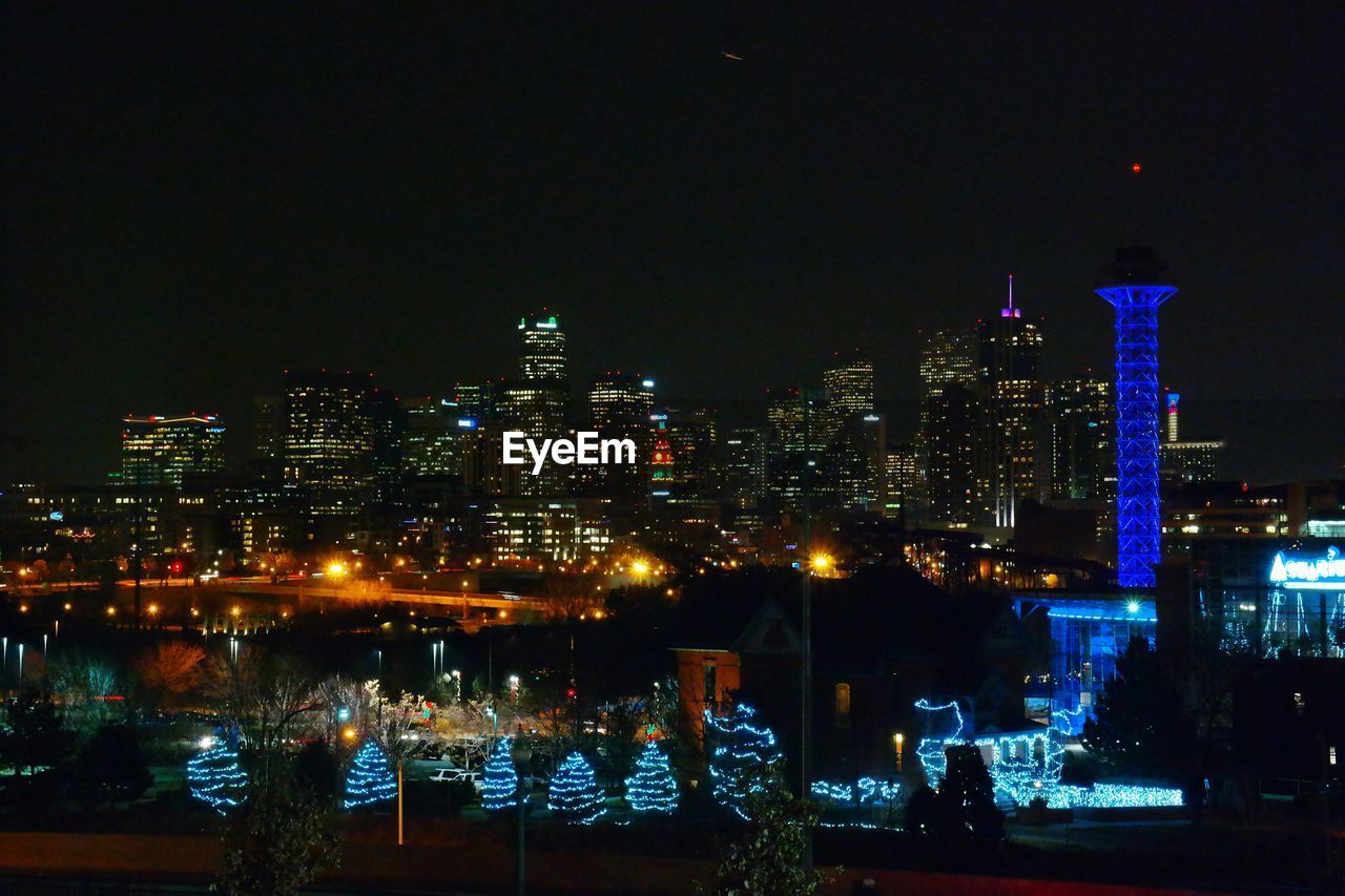 VIEW OF ILLUMINATED CITYSCAPE AT NIGHT