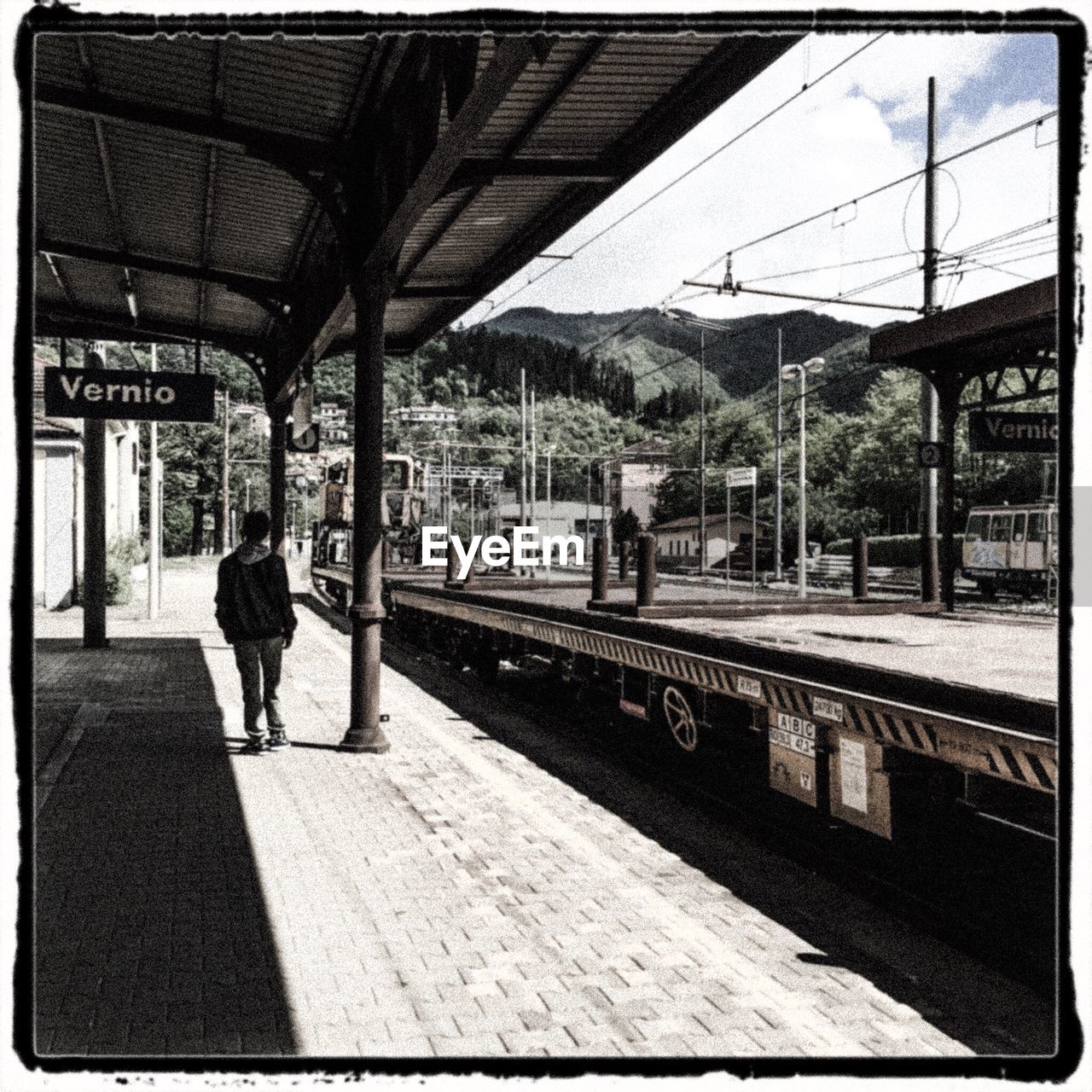 TRAIN ON RAILROAD STATION PLATFORM