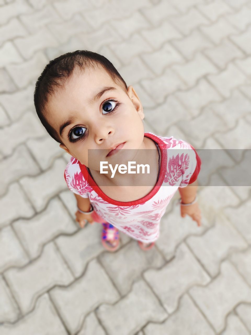 Portrait of cute baby girl lying on floor