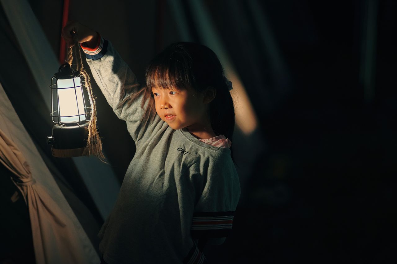 Cute girl holding lantern
