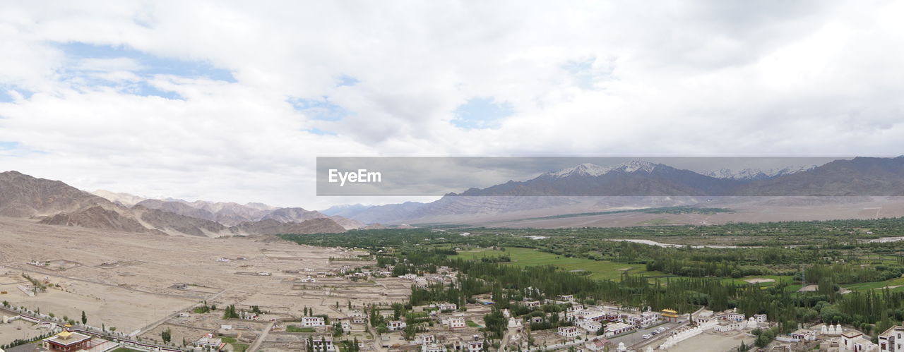 Scenic view of mountains against cloudy sky