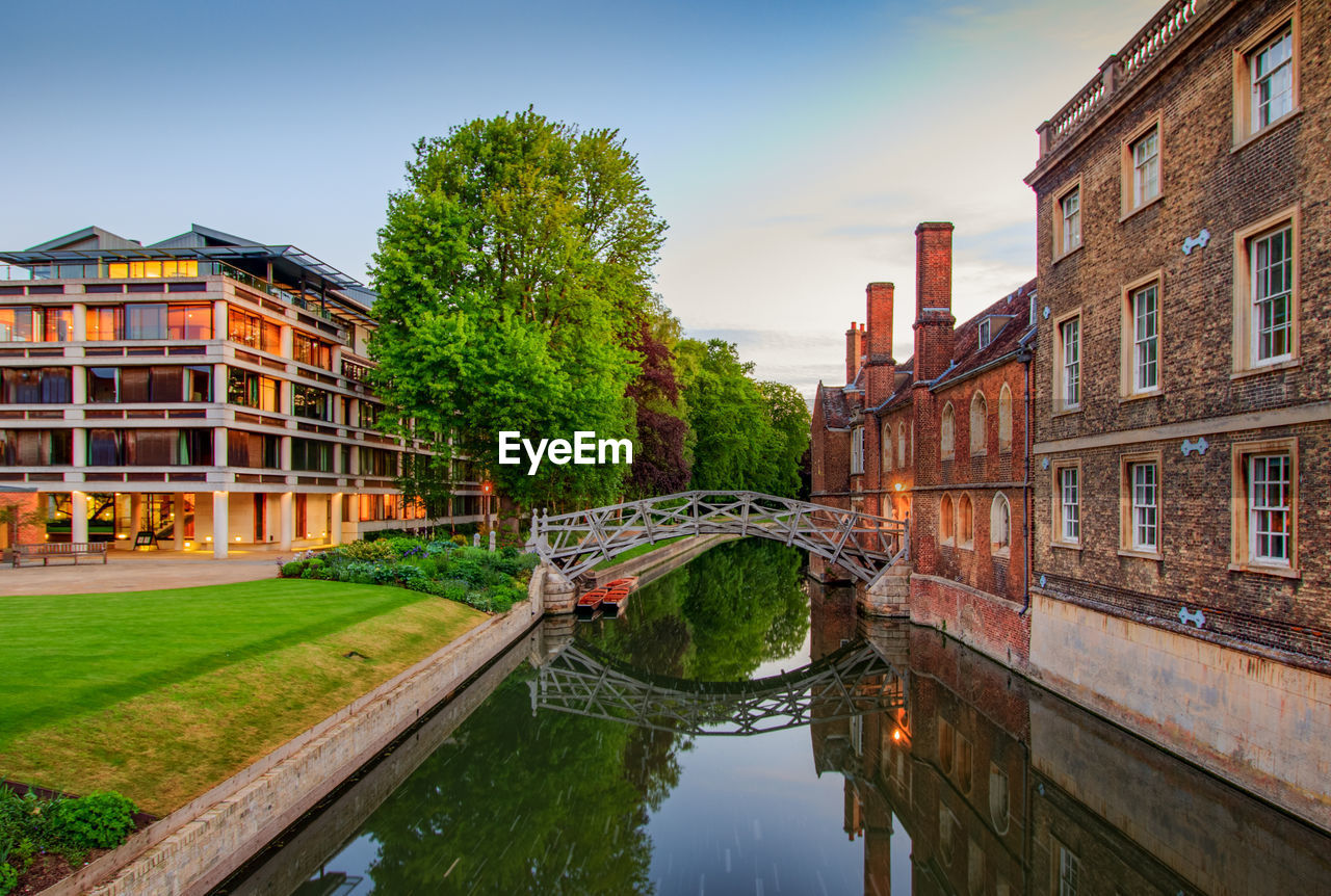 Bridge over canal amidst buildings against sky