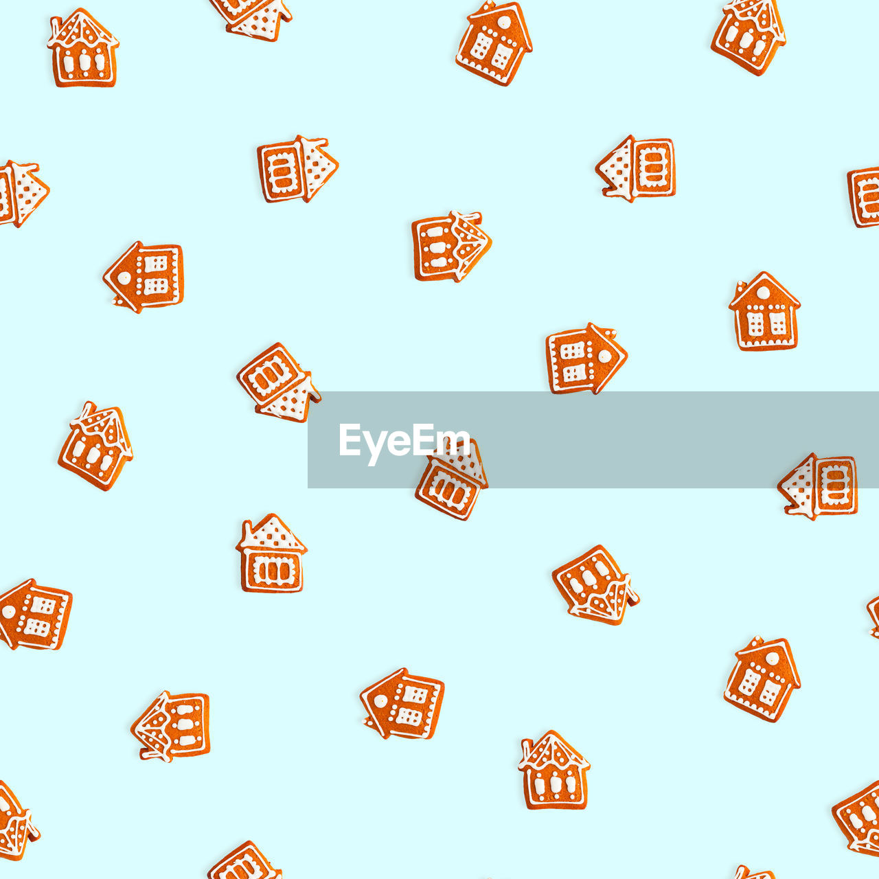 Gingerbread houses on blue background. seamless christmas pattern.