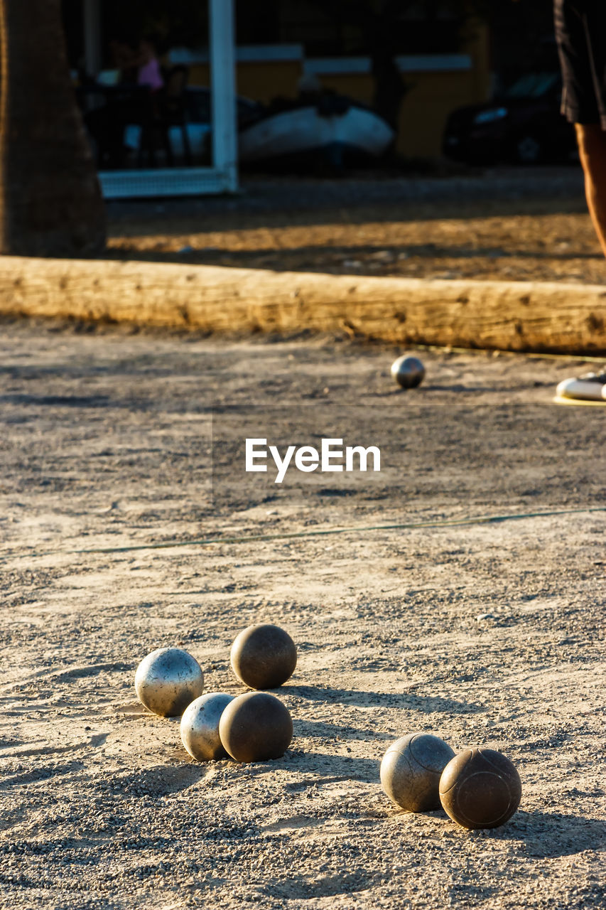 Game of petanque on the ground. verical image.