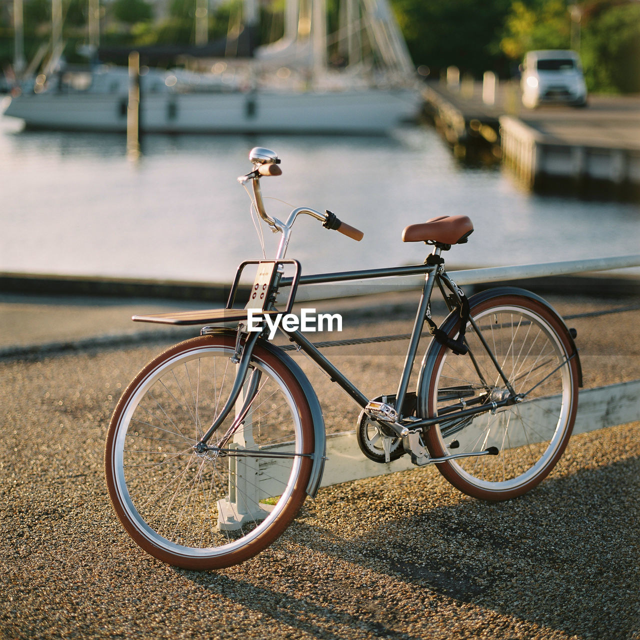 Close-up of bicycle by water