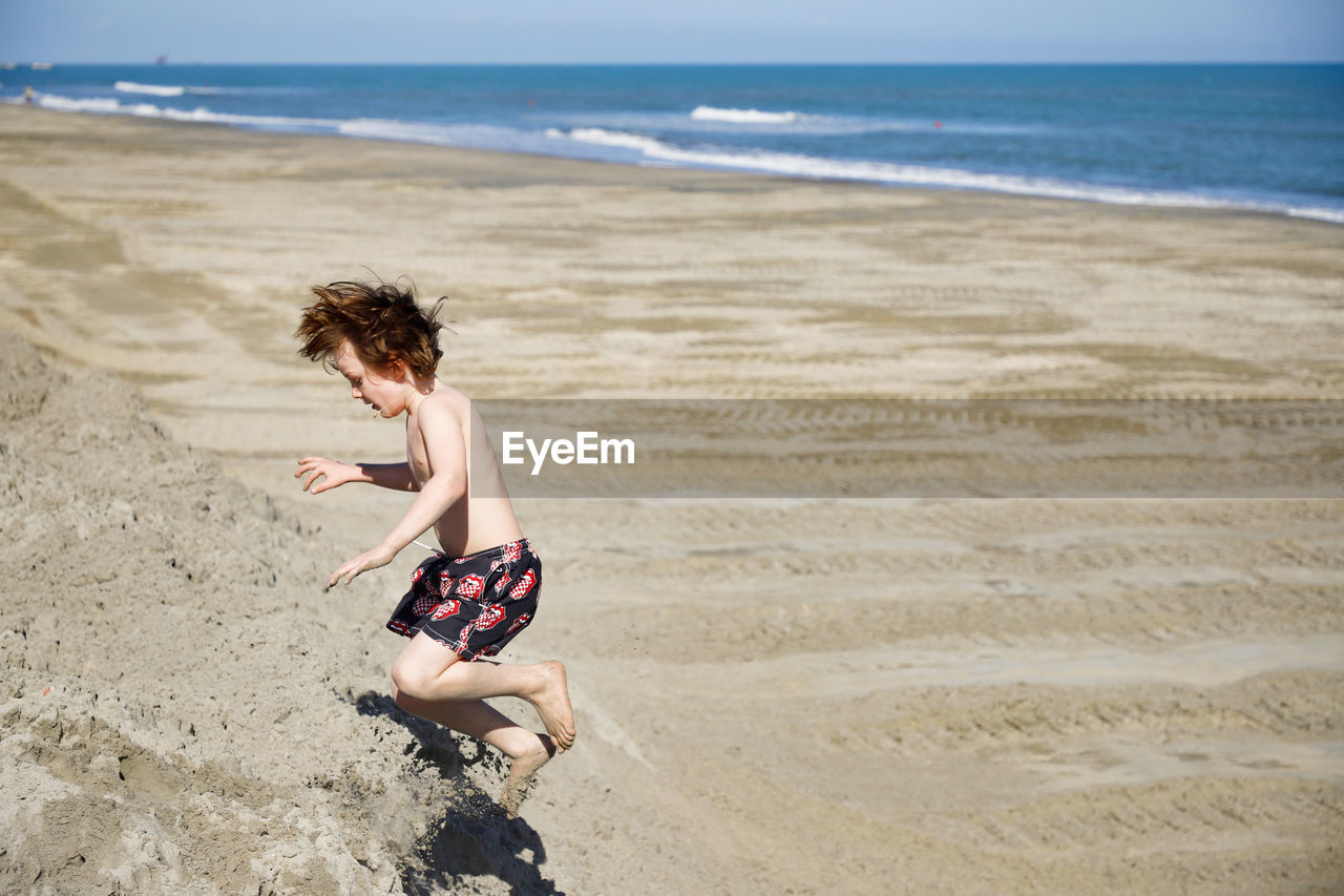 BOY ENJOYING ON BEACH