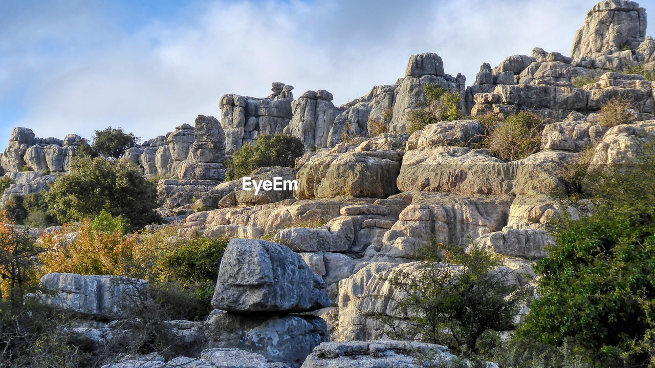 Panoramic view of rocks and trees against sky