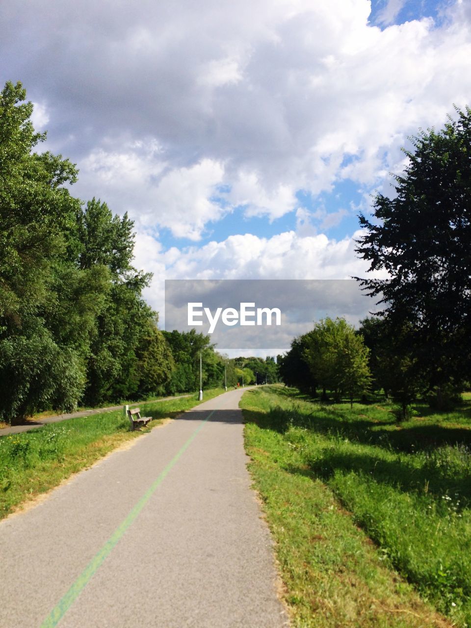 Empty road against cloudy sky