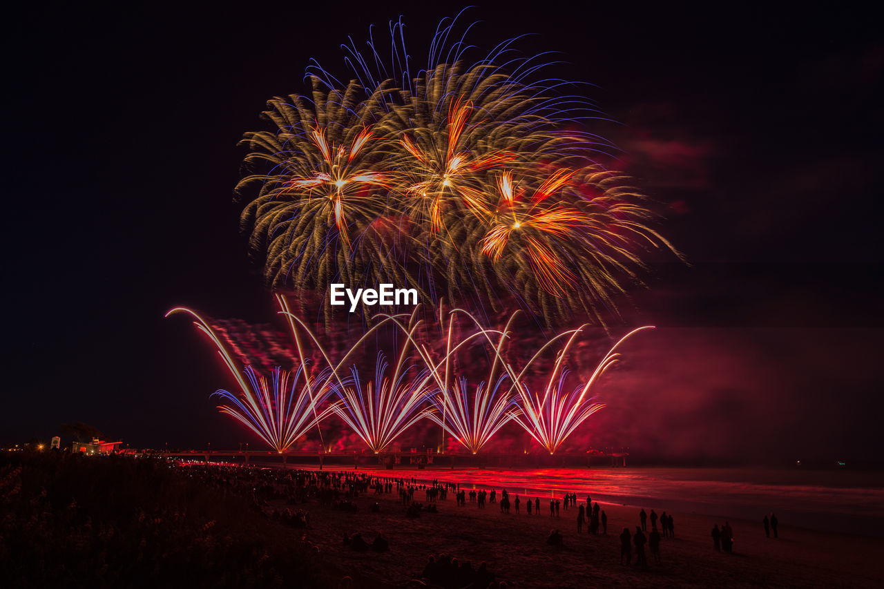 LOW ANGLE VIEW OF FIREWORK DISPLAY IN SKY AT NIGHT