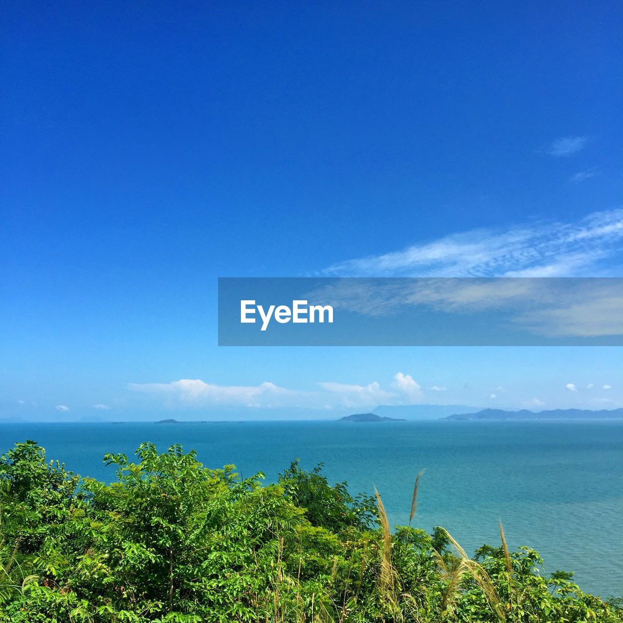 Scenic view of sea against blue sky