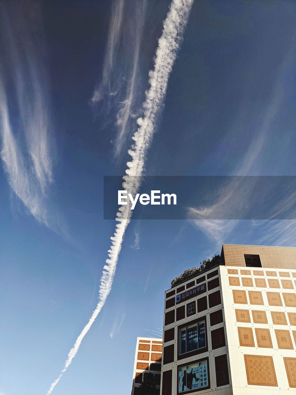 sky, cloud, vapor trail, architecture, building exterior, built structure, nature, building, low angle view, skyscraper, blue, no people, city, day, outdoors, transportation, airplane