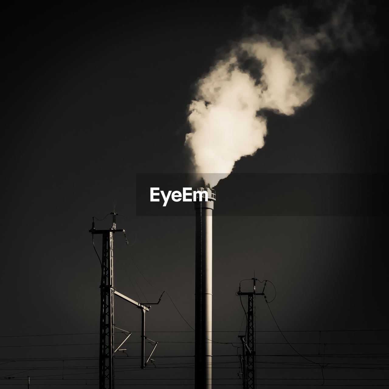 SMOKE EMITTING FROM CHIMNEY AT NIGHT