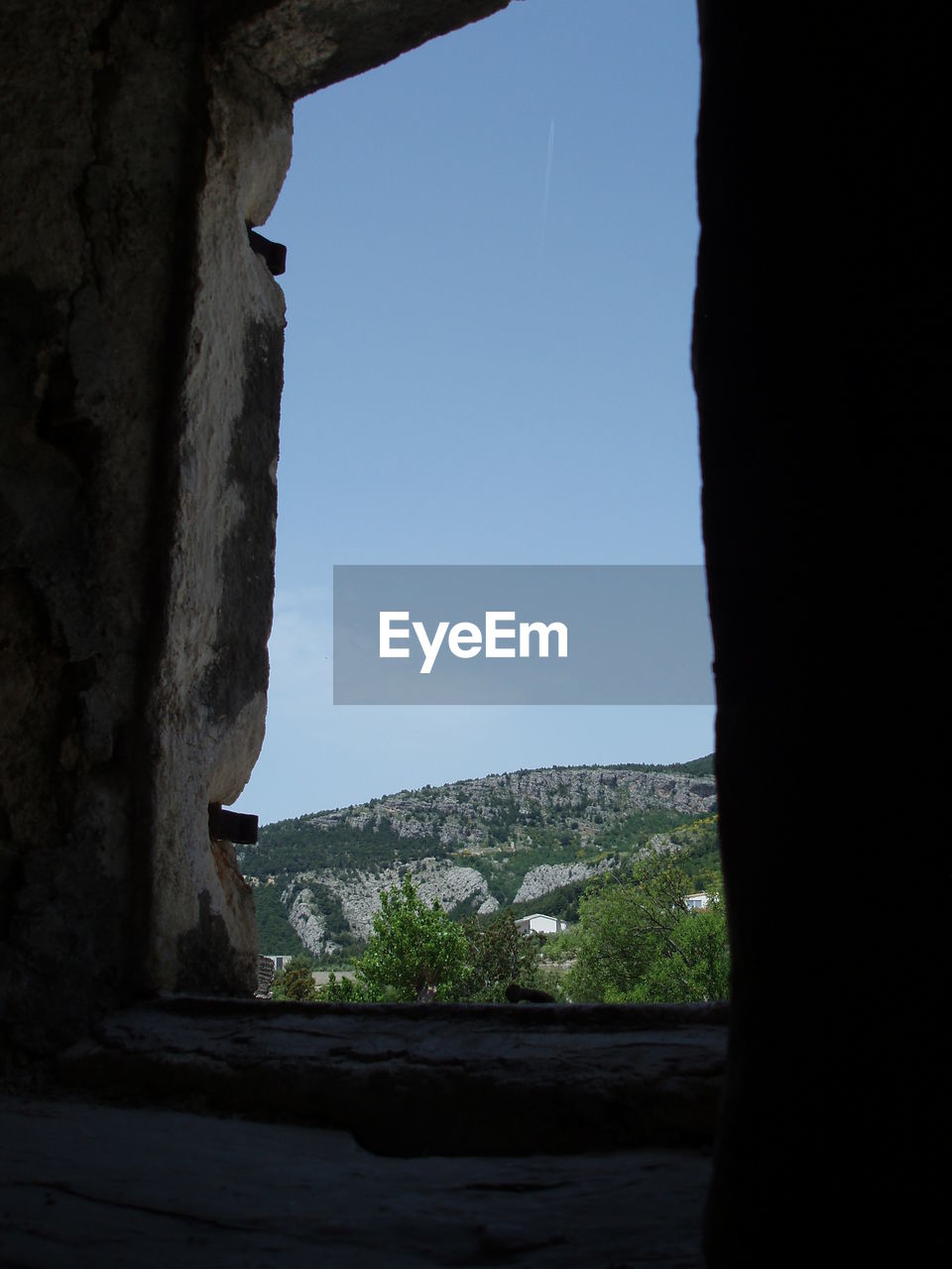 VIEW OF BUILT STRUCTURE THROUGH WINDOW