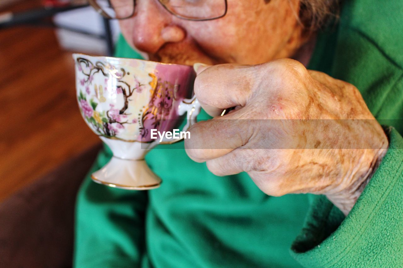 Midsection of woman drinking coffee in cup