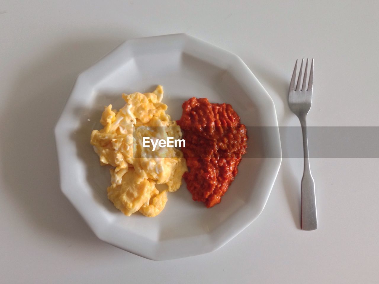 High angle view of scrambled eggs served in plate on table