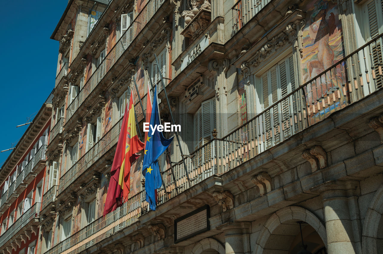 Facade of casa de la panaderia, bakery house, building with flags on the plaza mayor, madrid, spain.