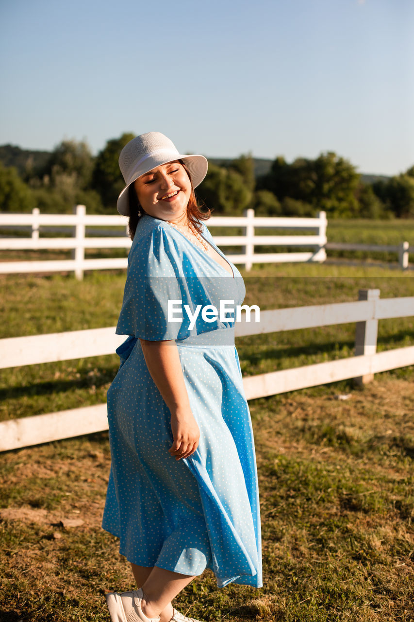 Portrait of smiling woman standing on field