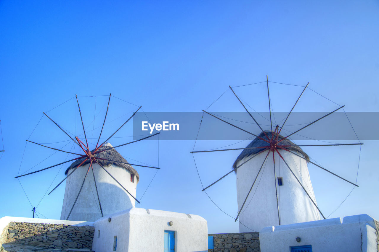 LOW ANGLE VIEW OF BUILT STRUCTURE AGAINST BLUE SKY