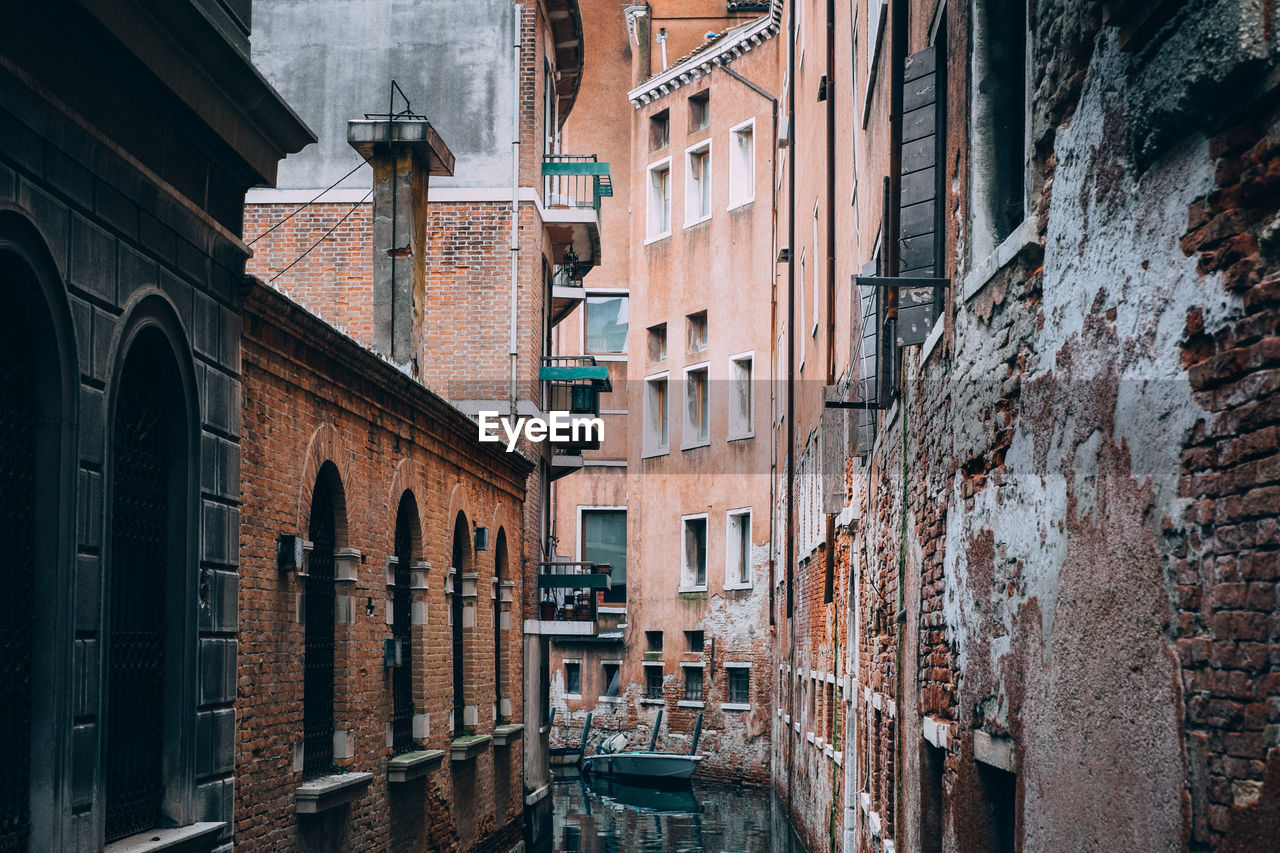 Canal amidst old buildings