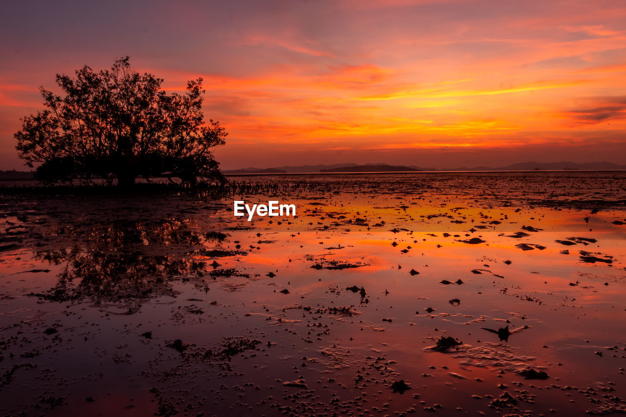 Scenic view of sea against romantic sky at sunset