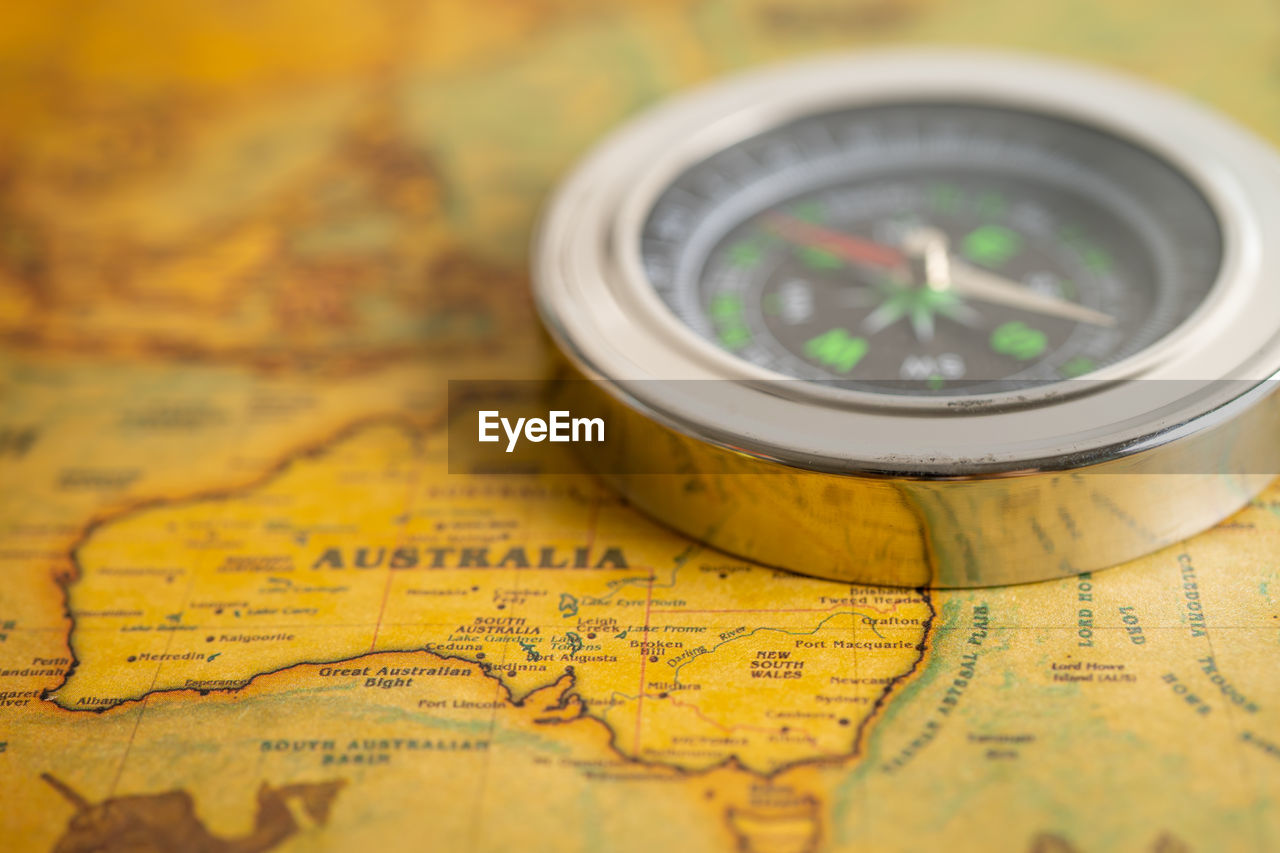 Close-up of navigational compass on table