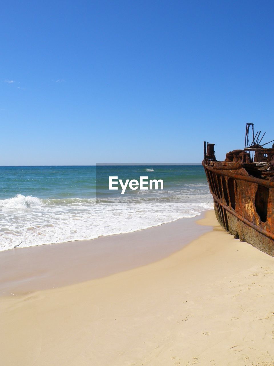 Rusty abandoned boat at beach