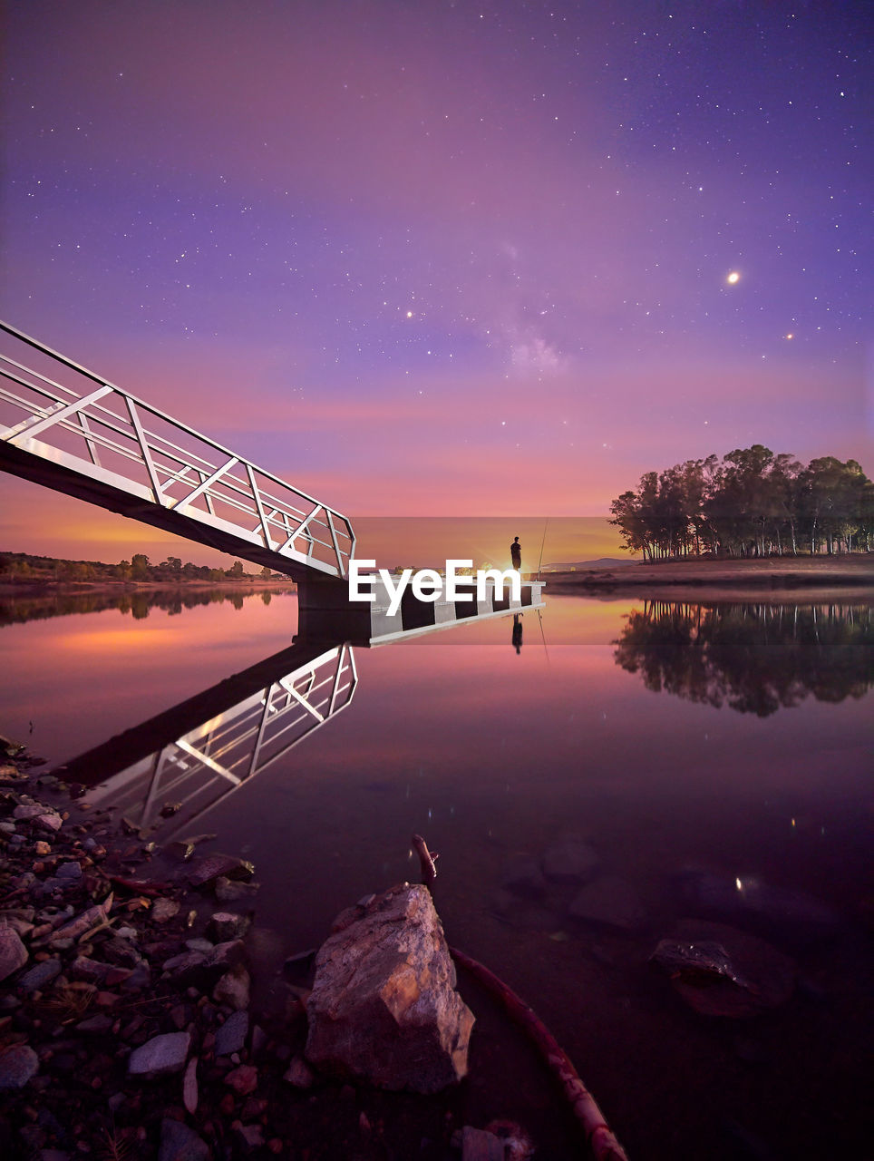 Scenic view of lake against sky at night