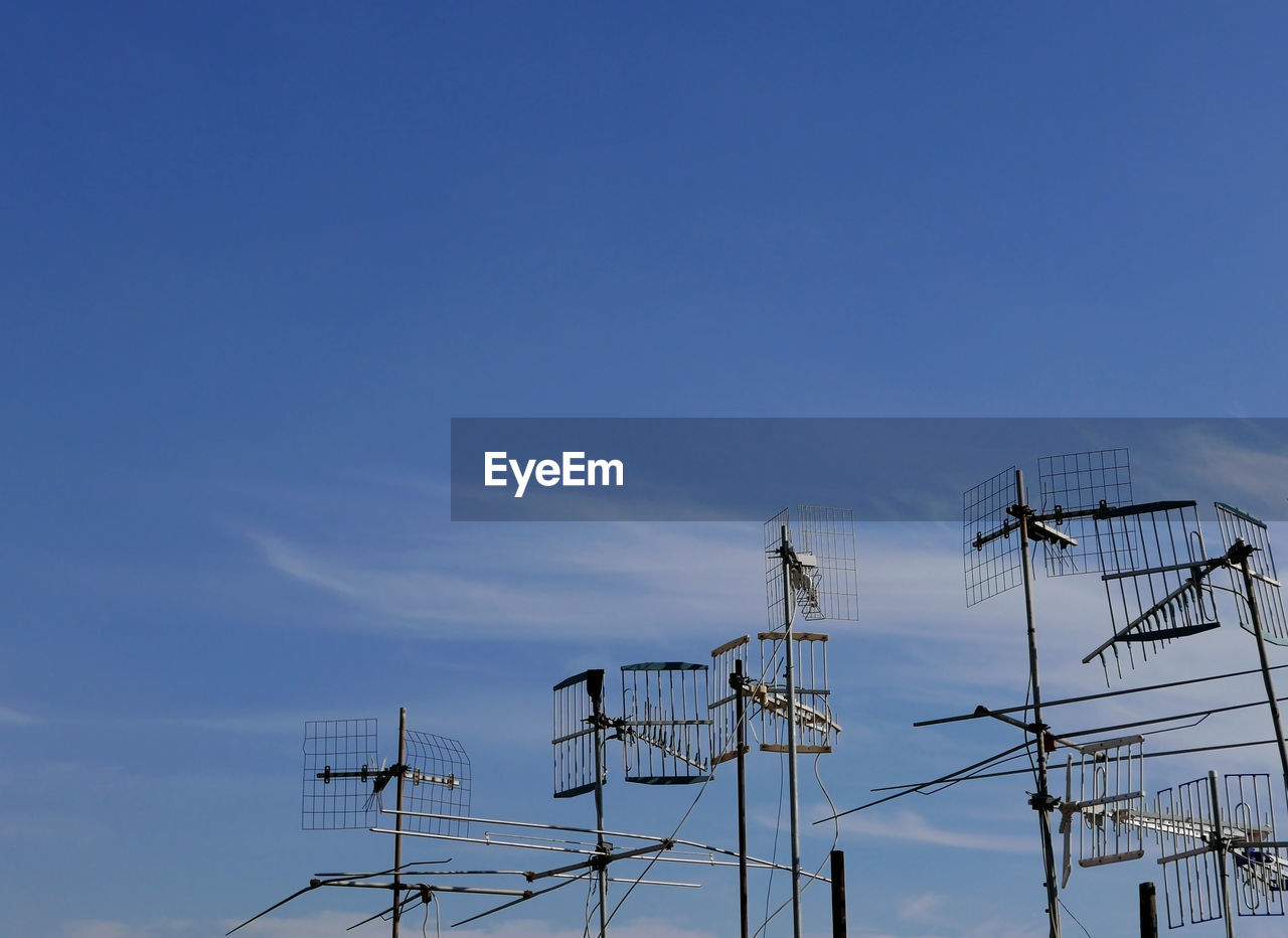 A group of antennas against the clear sky