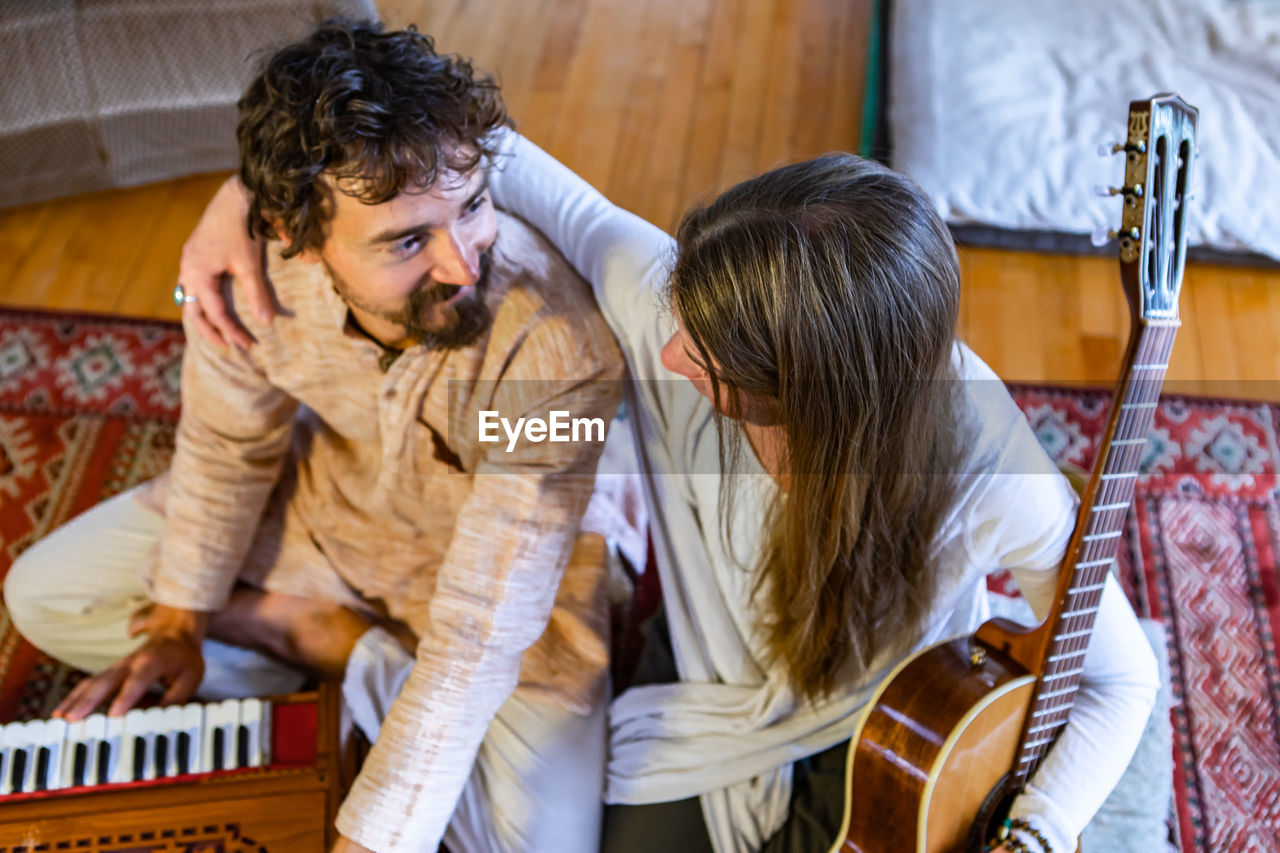 Young couple playing at music concert