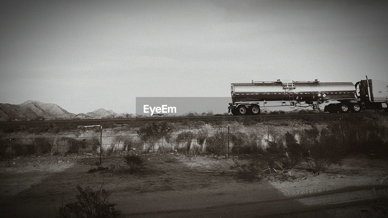 Commercial land vehicle on road against sky