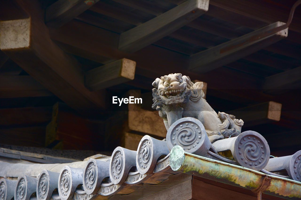 Gargoyle on roof of traditional building